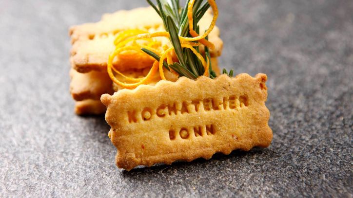 Lieblingsrezept: Knusprige Rosmarin-Orangen Plätzchen mit Kochatelier-Bonn-Aufdruck – Frühlingsplätzchen, die den Sommer mit mediterranen Aromen ankündigen. Zu Kaffee oder Eiscreme ein Genuss!
 Lieblingsrezept: Knusprige Rosmarin-Orangen Plätzchen mit Kochatelier-Bonn-Aufdruck